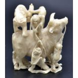 A Japanese ivory okimono, eight monkeys on and around a standing frisky oxon,
