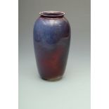 A Ruskin ovoid high-fired vase with slightly flared rim, red and purple/blue mottled glaze,