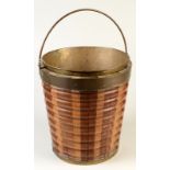 A 19th century Dutch brass bound bucket, the swing handle above a shallow brass liner, the tapering,