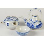 A Japanese blue and white Banko Ware teapot and cover, floral decoration,