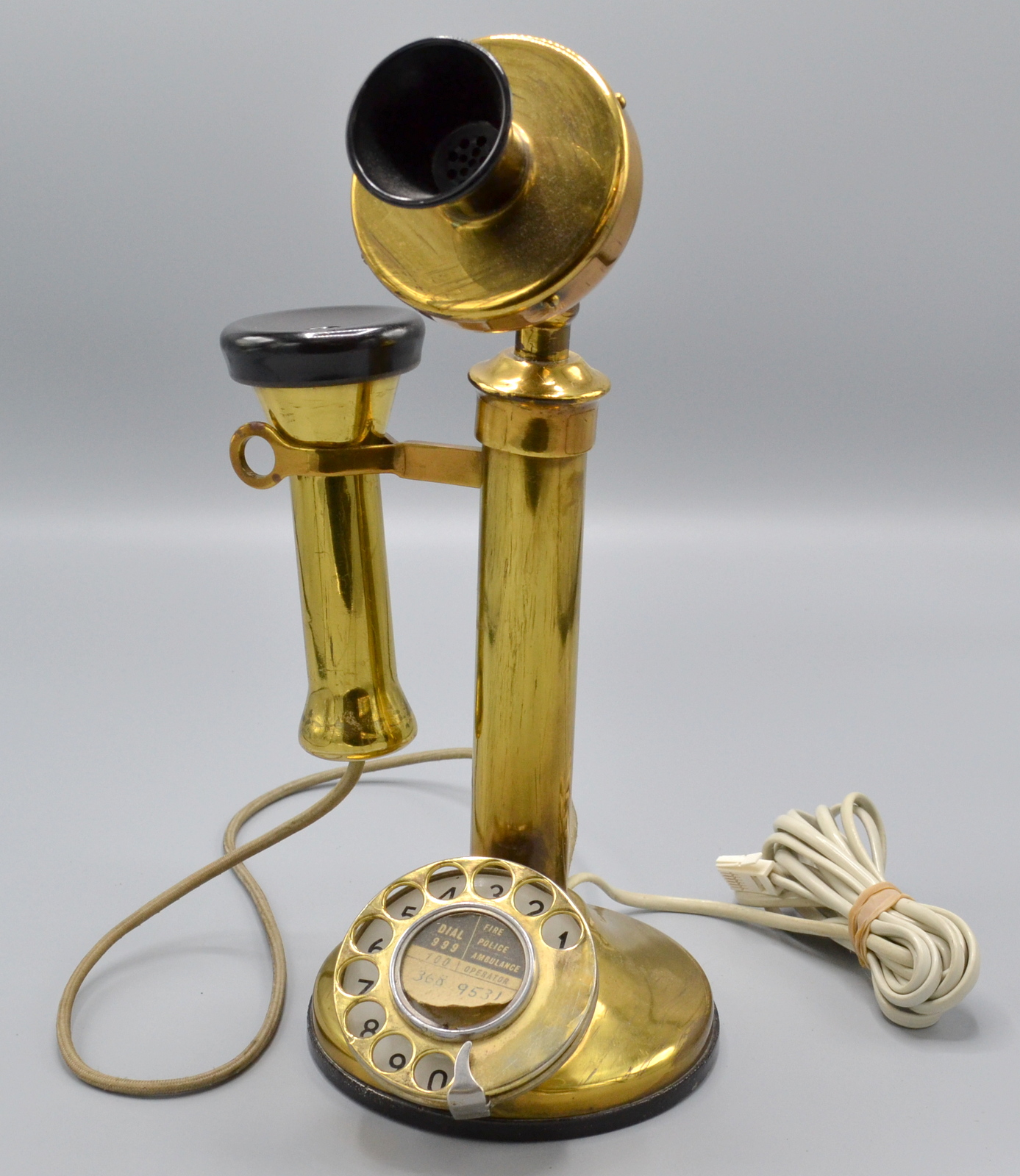 A brass candlestick telephone.