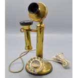 A brass candlestick telephone.