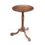 A late 17th or early 18th century oak tripod table, diameter 37cm, height 58cm.