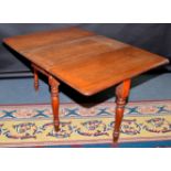 A Victorian mahogany twin flap dining table on turned legs.
