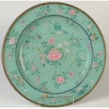 A Chinese Canton enamel salver decorated with a central peony motif surrounded by symbolic flowers
