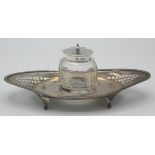 A pierced oval silver ink stand with detachable cut glass inkwell, Sheffield 1898.