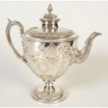A good Victorian plated tea pot with swags and mask, the lid with a pineapple finial, height 24cm.