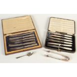 A set of six cased tea knives with filled silver handles,