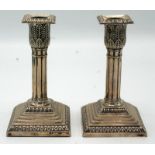 A pair of late Victorian, filled silver, cluster column candlesticks with detachable nozzles,