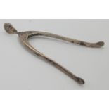 A pair of sprung, wishbone silver sugar tongs.