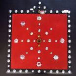 A collection of fire brigade badges and buttons on a display board.