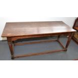 An oak refectory table on turned legs with low stretchers, 74.5 x 183.5cm.