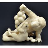 An ivory okimono, a monkey, a squirrel and grapes. Late Meiji. Height 5.6cm, width 6.5cm.