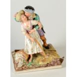 A 19th century pottery group of a courting couple, the base with blue painted mark 'H39',