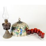 A brass and coloured glass oil lamp, height 43cm, a Tiffany style stained glass hanging lamp shade,