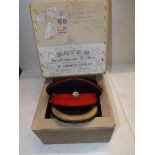 An Officer's dress cap with Royal Anglian cap badge, contained in a hat box for Bates,