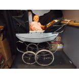 A silver cross twin child's pram (full height 38") a soft plastic doll with sleep eyes and a