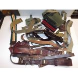 A collection of military belts, straps, Sam Brown etc.