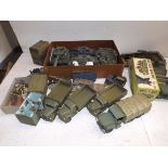 A collection of plastic military vehicles contained in two boxes,