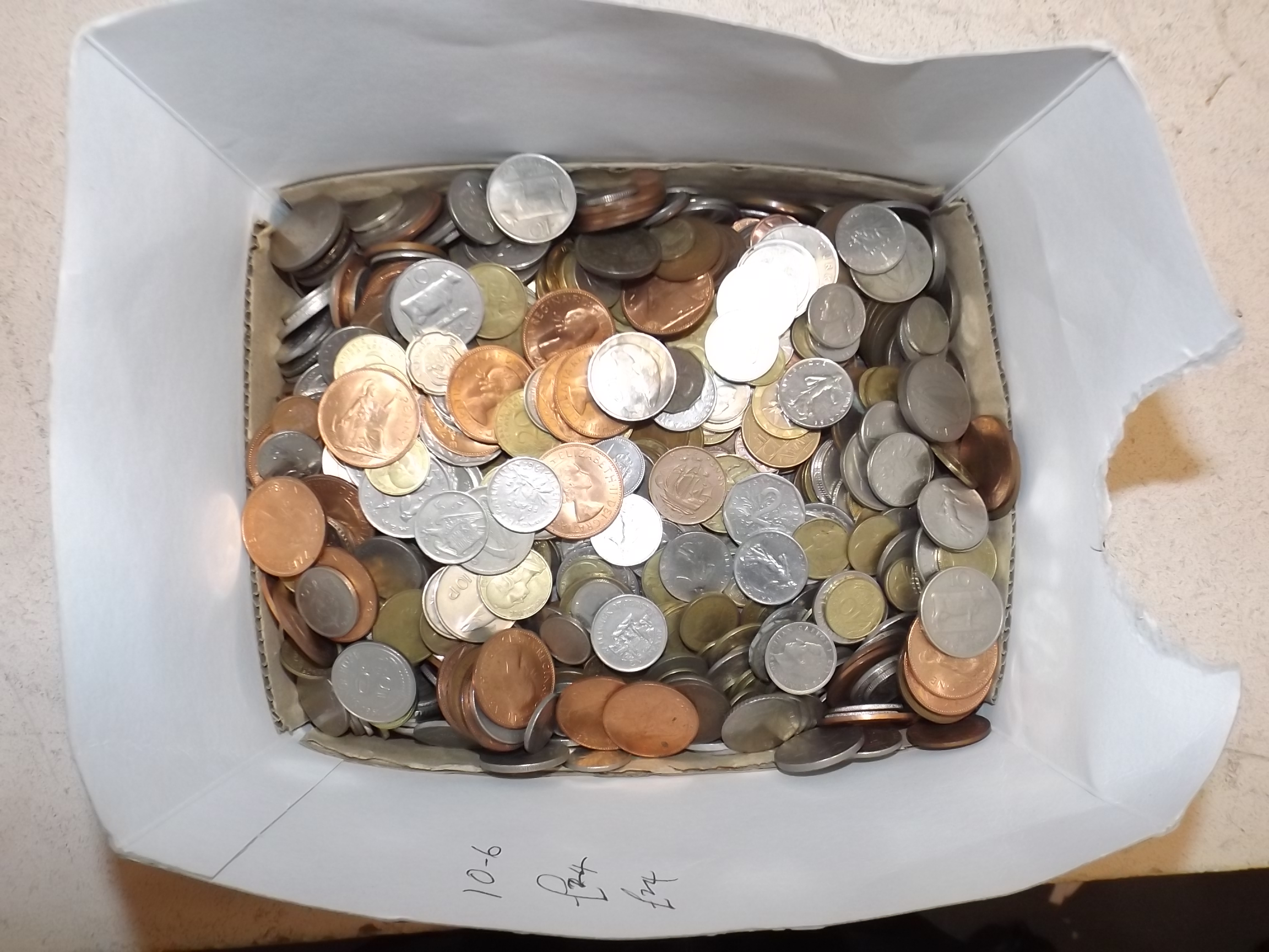 A large and heavy quantity of world coins.
