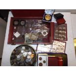 A quantity of coins in a wood box, tin and loose.
