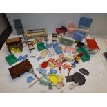 A collection of dolls house furniture including plastic, tin and die-cast.