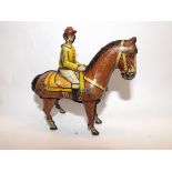 A German tin plate clockwork horse and jockey, printed under "K900, DRPa, Germany, D.R.G.M.