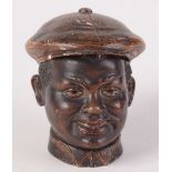 A pottery tobacco jar and cover, in the form of smiling negro's head, incised 'B.