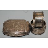 A pair of silver napkin rings and an 18th century continental silver snuff box.