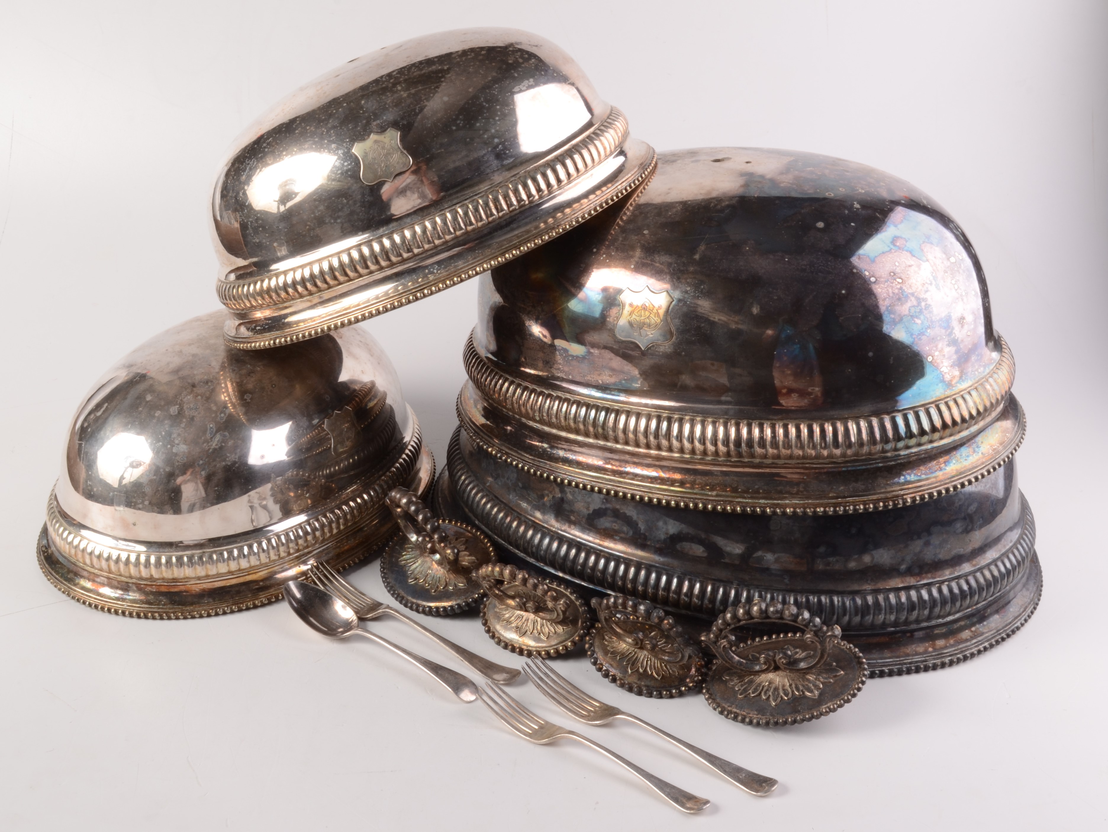 Four Victorian silver plated meat covers, each monogrammed on a shield shaped plaque,