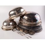 Four Victorian silver plated meat covers, each monogrammed on a shield shaped plaque,