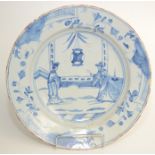 A Delft pottery blue and white dish, 18th century, with figures on a balcony,