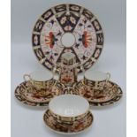 A Royal Crown Derby tray, no 2451, diameter 23cm, cream jug, two side plates, two cups,