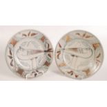 A pair of Seth Cardew Wenford Bridge studio pottery plates, each decorated with a bird to the well,