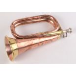 A WWI copper and brass bugle with silver plated mouthpiece by Hawkes & Son Makers, Denman Street,
