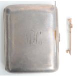 A silver cigarette case and a gold bar brooch.