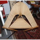 A stylish 1970s style cane corner chair with a triangular seat,