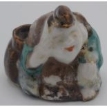 A Chinese porcelain water dropper in the form of a seated figure, height 5.5cm.