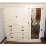 A high Victorian painted softwood combination wardrobe with a mirrored door beside a pair of blind