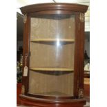 A small hanging display corner cabinet.