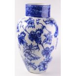 A large flow blue pottery vase, the ivory ground decorated with flowering vines,