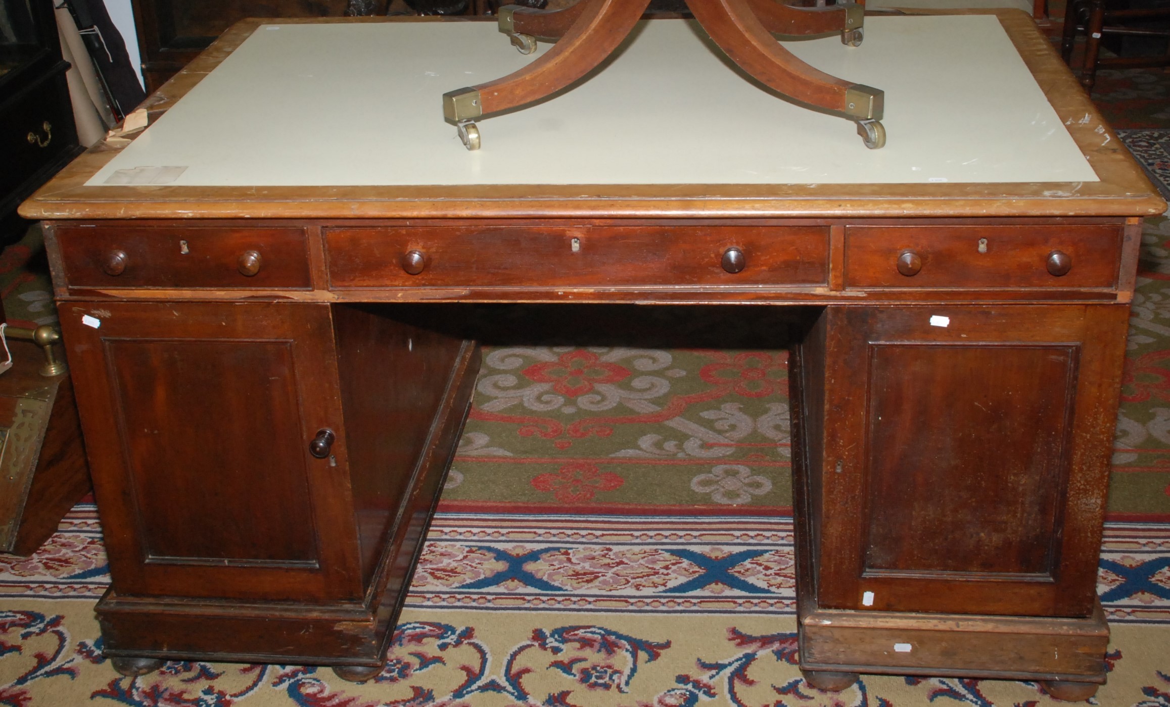 A 19th century mahogany partners desk with twin pedestals, one side fitted drawers,