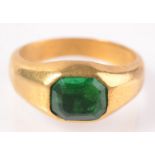 A very high purity gold ring set an emerald in early stirrup style. 10.8g.