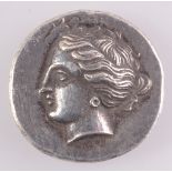 A Greek silver style drachma coin, the obverse with the head of Aphrodite,