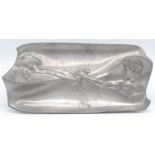 An Art Nouveau pewter dish, decorated with a young couple, 14.5 x 29cm.