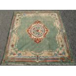 An Indian carpet, the green field with a large central oval lobed medallion,