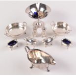 A pair of three piece cruets with two spare blue glass liners and four other pieces.