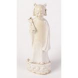 A Chinnese de-hua porcelain figure of a youthful smiling acolyte with a scarf head piece around