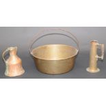 A large brass circular pan, with wrought iron handle, diameter 47cm and two copper jugs.