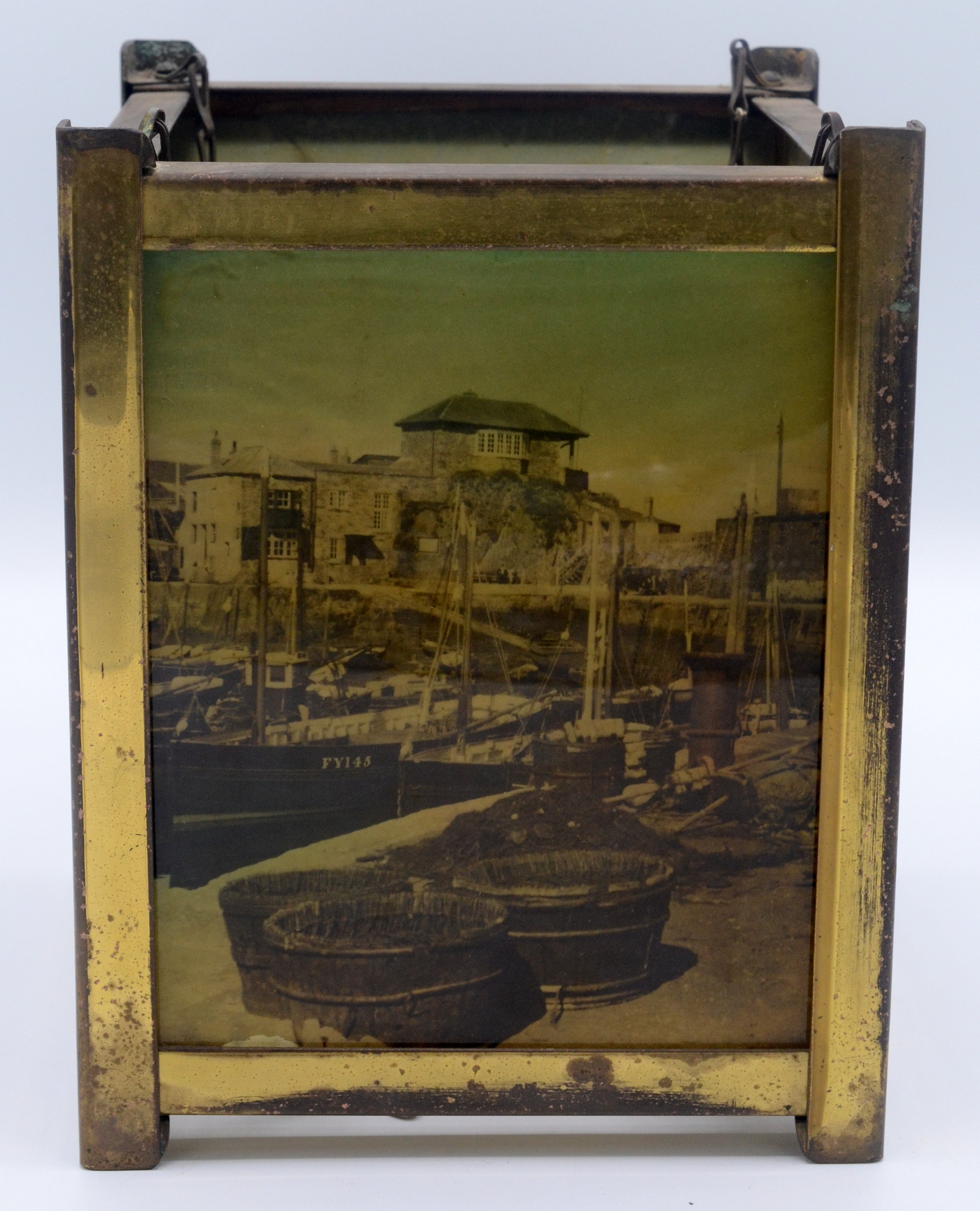 A brass hall lantern, with four photographic glass panels showing coastal and river scenes,